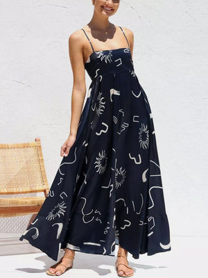Dark Navy spaghetti strap maxi dress with abstract white print, square neckline, and flowing skirt.