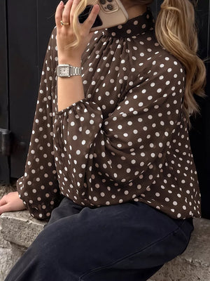 white blouse featuring buttoned and polka dot