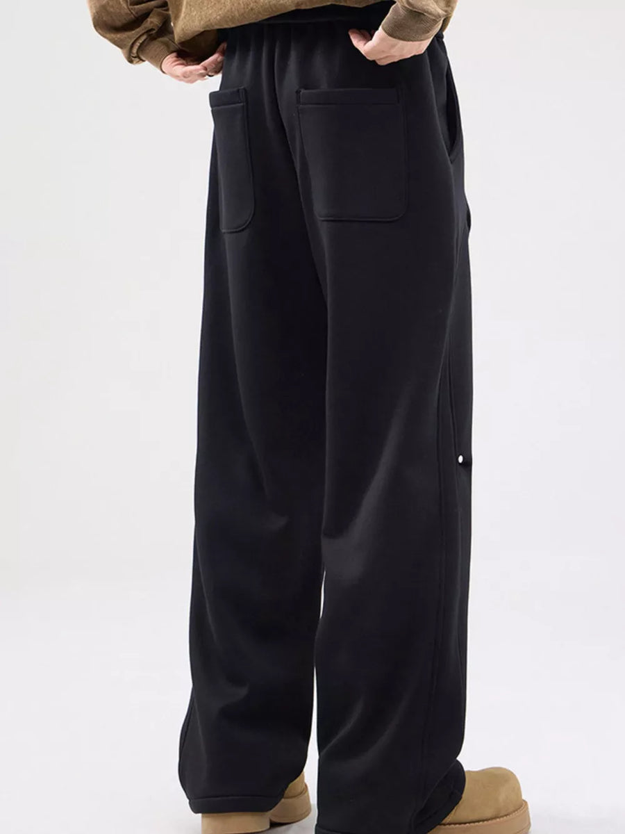 Black casual sweatpants with loose fit and back pockets.