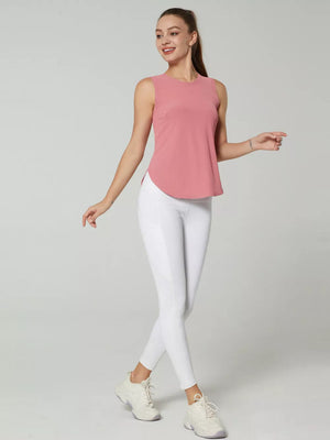 Sleeveless pink athletic tank top with curved hem and white leggings with side panel detail.