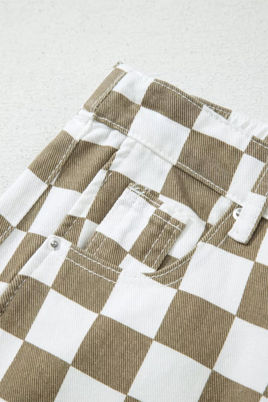 Maternity barrel pants in brown and white checkered denim with visible pockets and stitching.