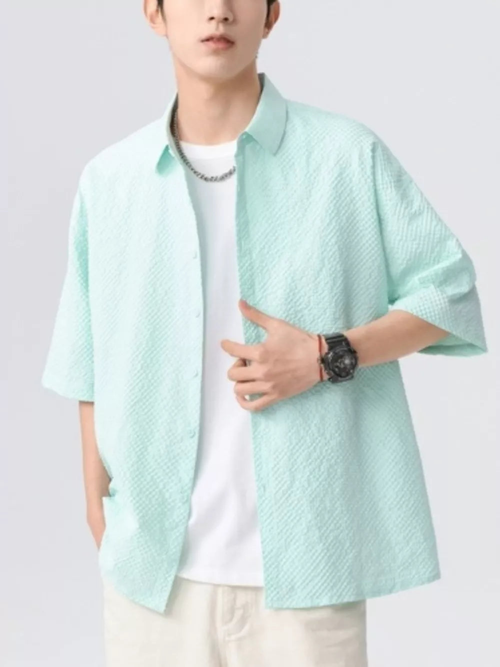 Textured mint green short-sleeve men's shirt with button-up front and spread collar.