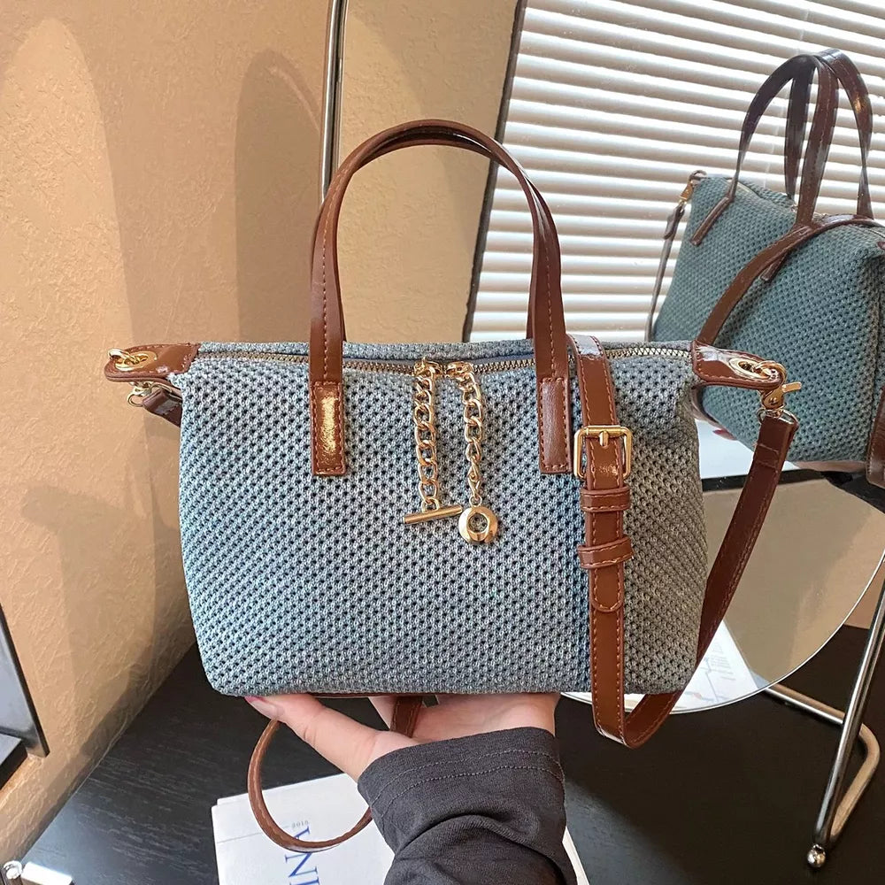 crossbody bag in dusty blue featuring woven texture and structured fit