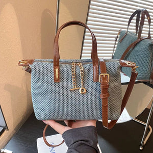 crossbody bag in dusty blue featuring woven texture and structured fit
