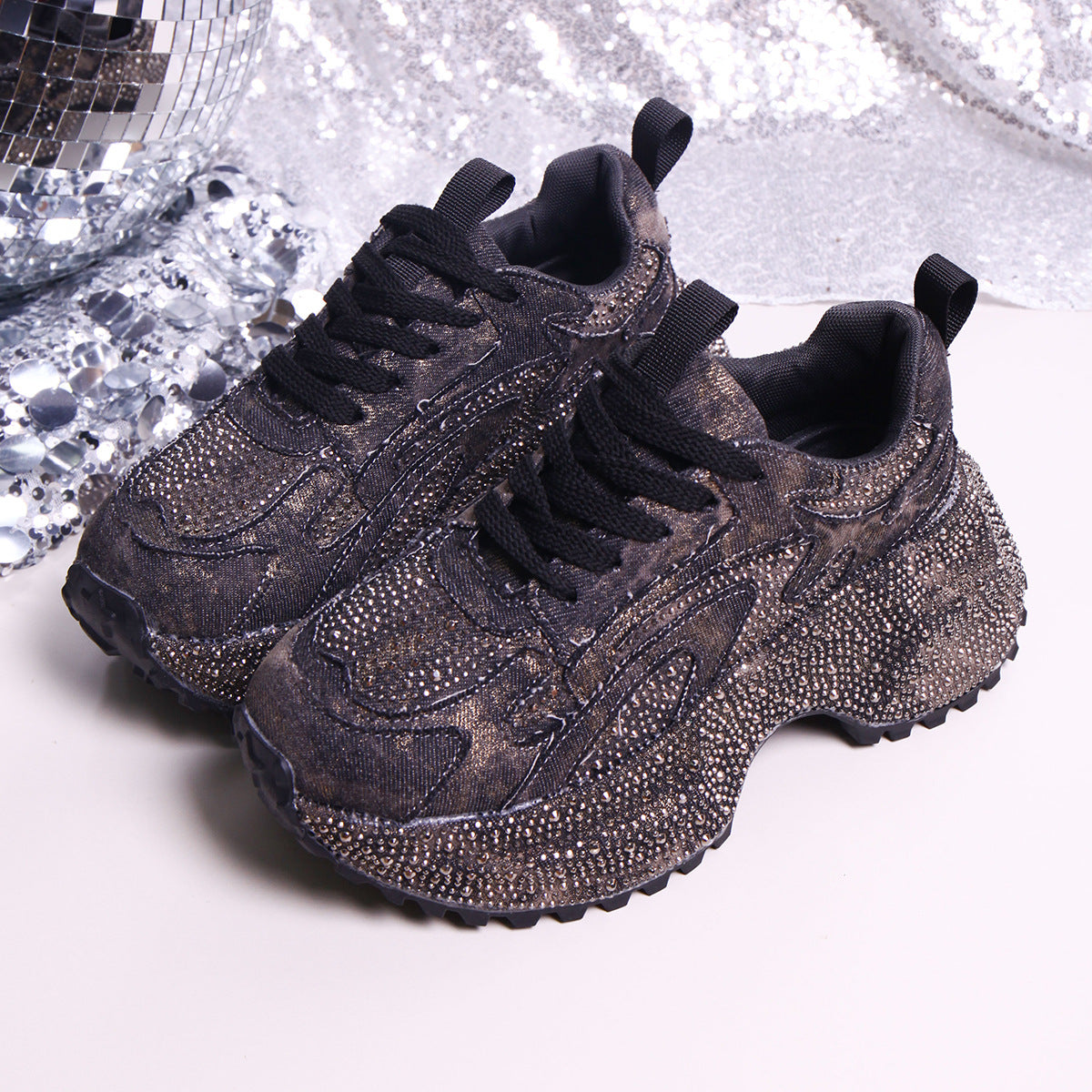 Black rhinestone high-heel platform sneakers with chunky soles and black laces.