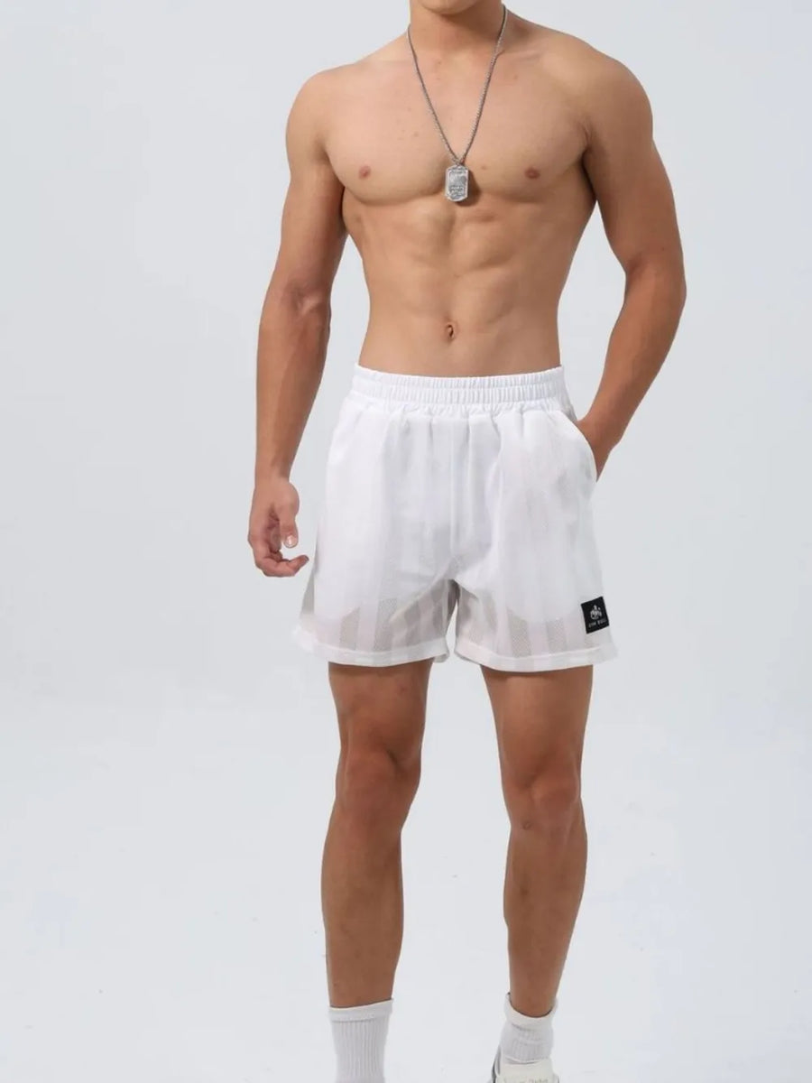 White performance mesh training shorts with vertical stripe detail and logo patch.