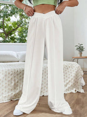 White V-waistline palazzo sweatpants with center seams and wide legs.