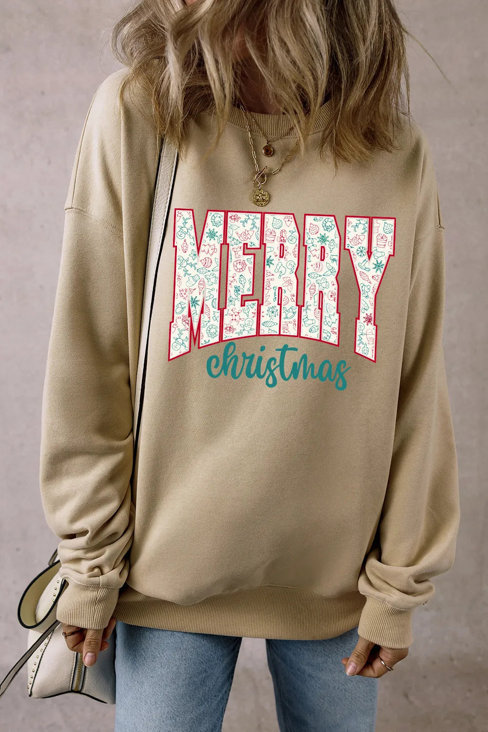 Khaki long sleeve sweatshirt with Merry Christmas graphic and festive holiday icons.