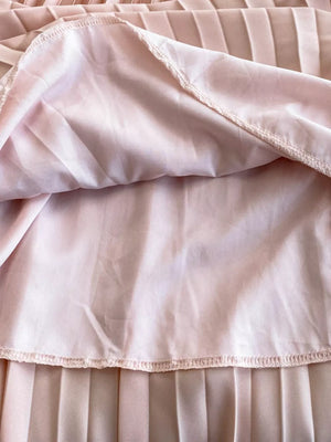 Pink pleated maxi dress detail showing lining and hem