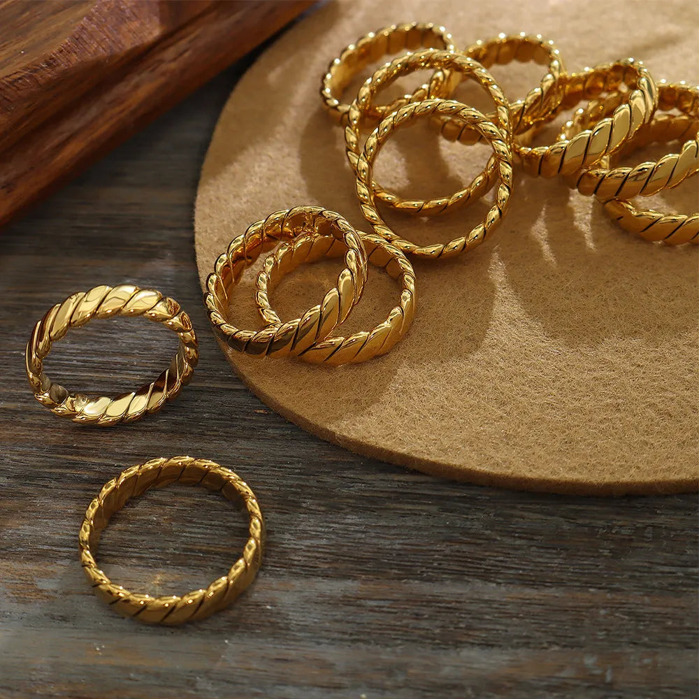 Gold braided titanium band ring with a twisted rope design