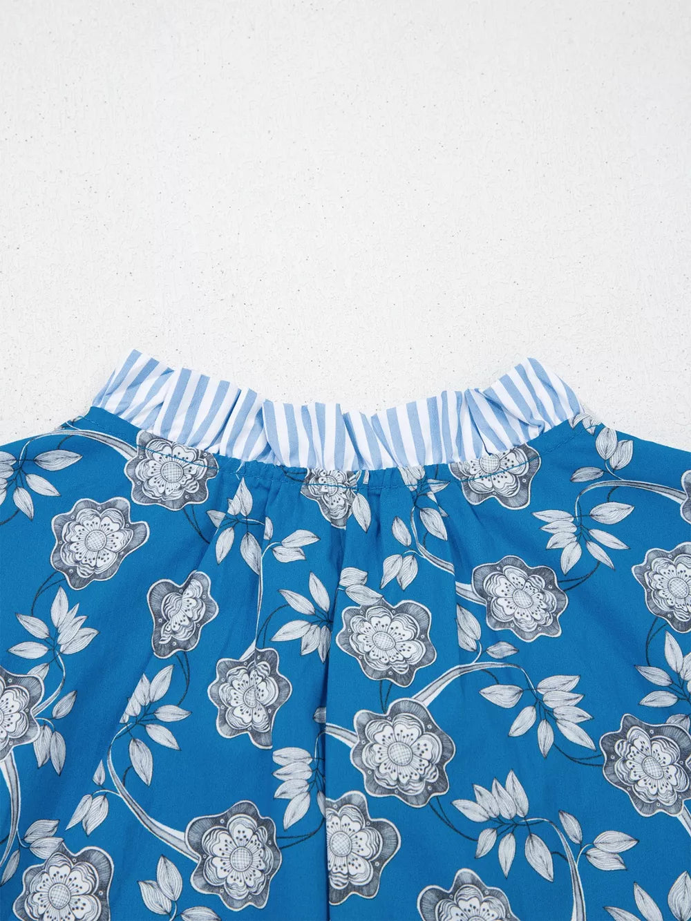 Blue cotton blouse with floral print and ruffled striped neckline