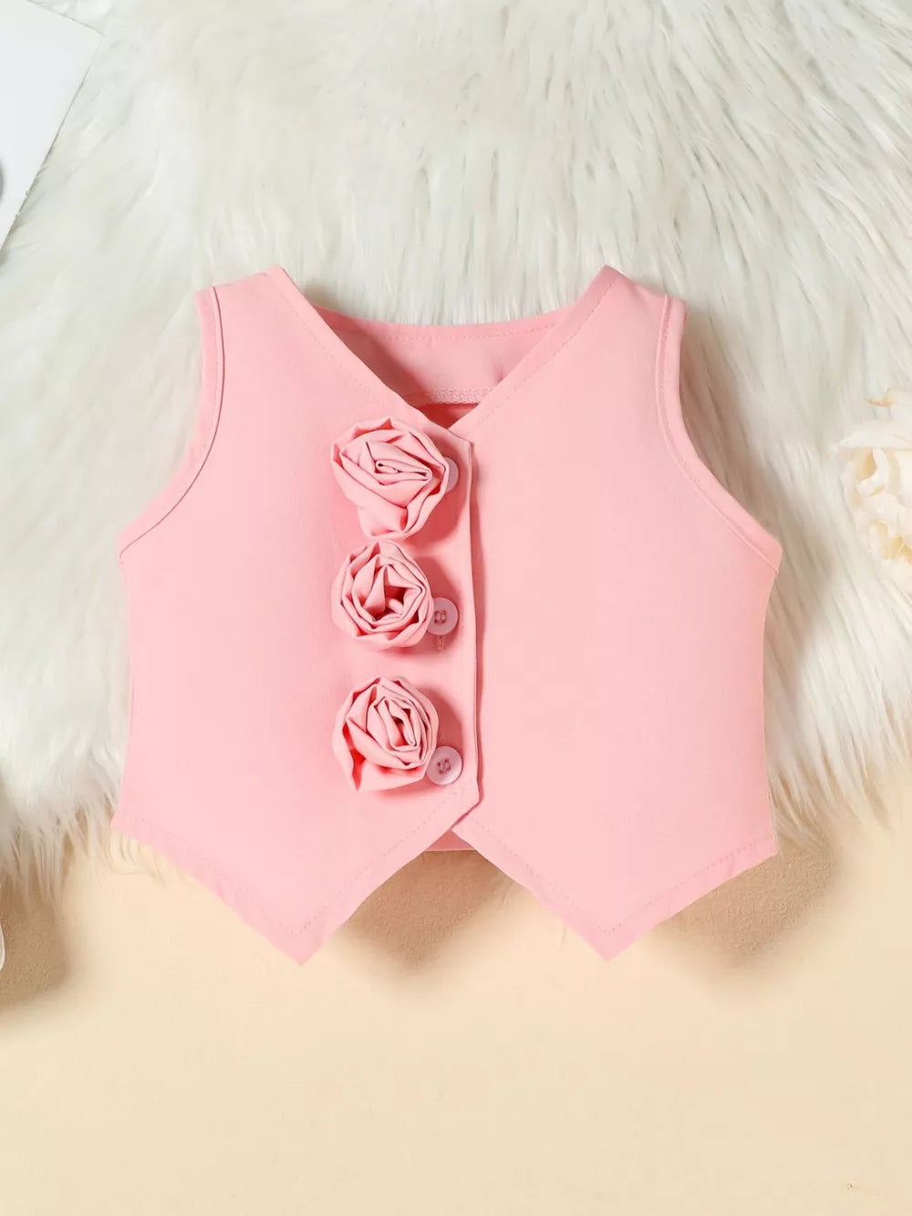 Pink baby vest with decorative floral buttons and V-neckline