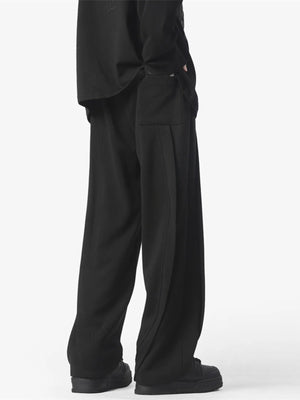Men's black loose fit drawstring pants with side pocket detail.