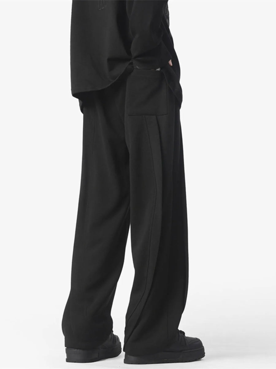 Men's black loose fit drawstring pants with side pocket detail.
