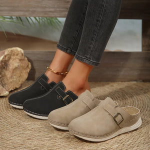 Buckle accent round-toe slip-on flats in khaki and black with contrast stitching.