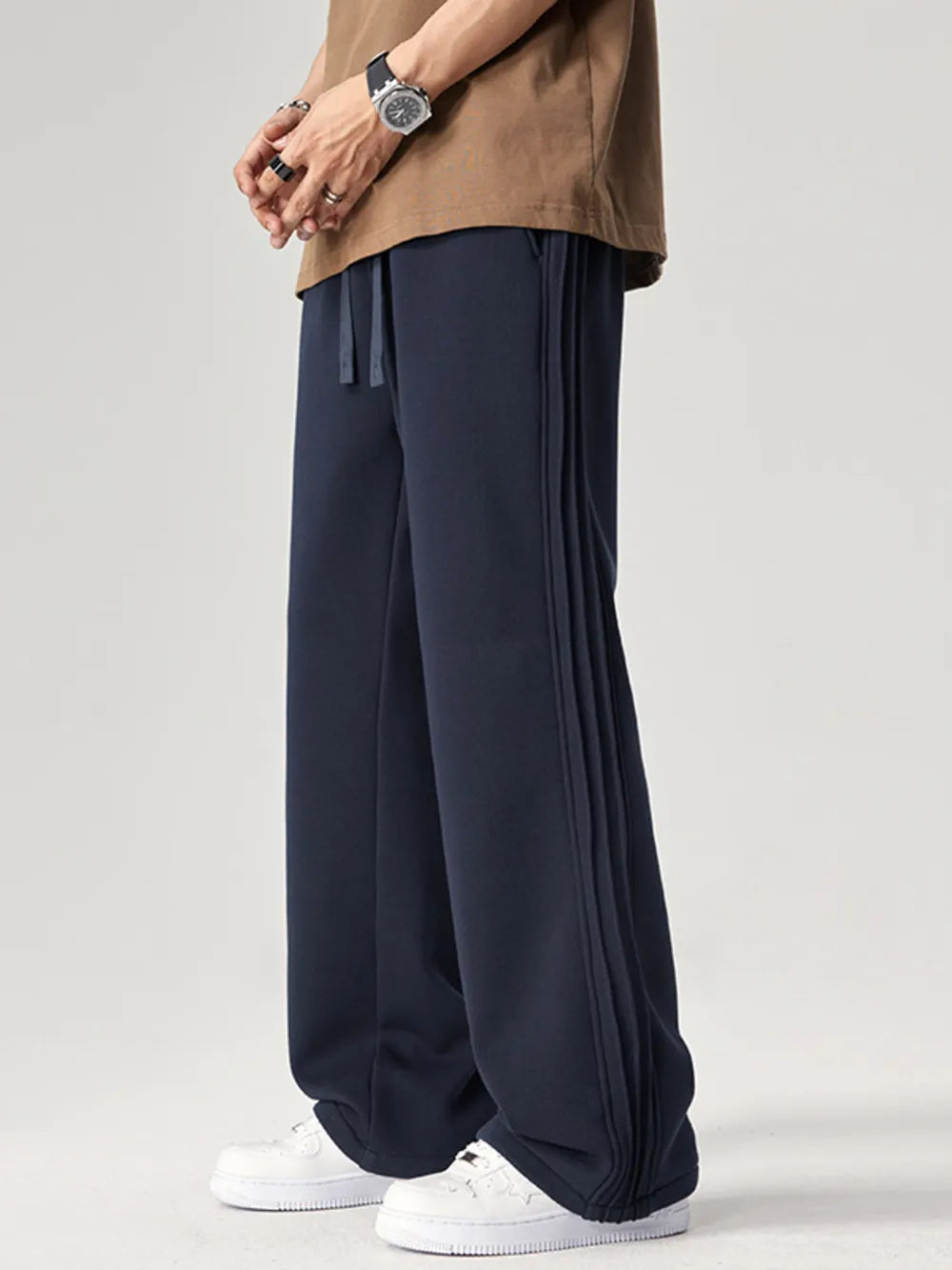 Men's navy relaxed fit sweatpants with drawstring and side seam detail.