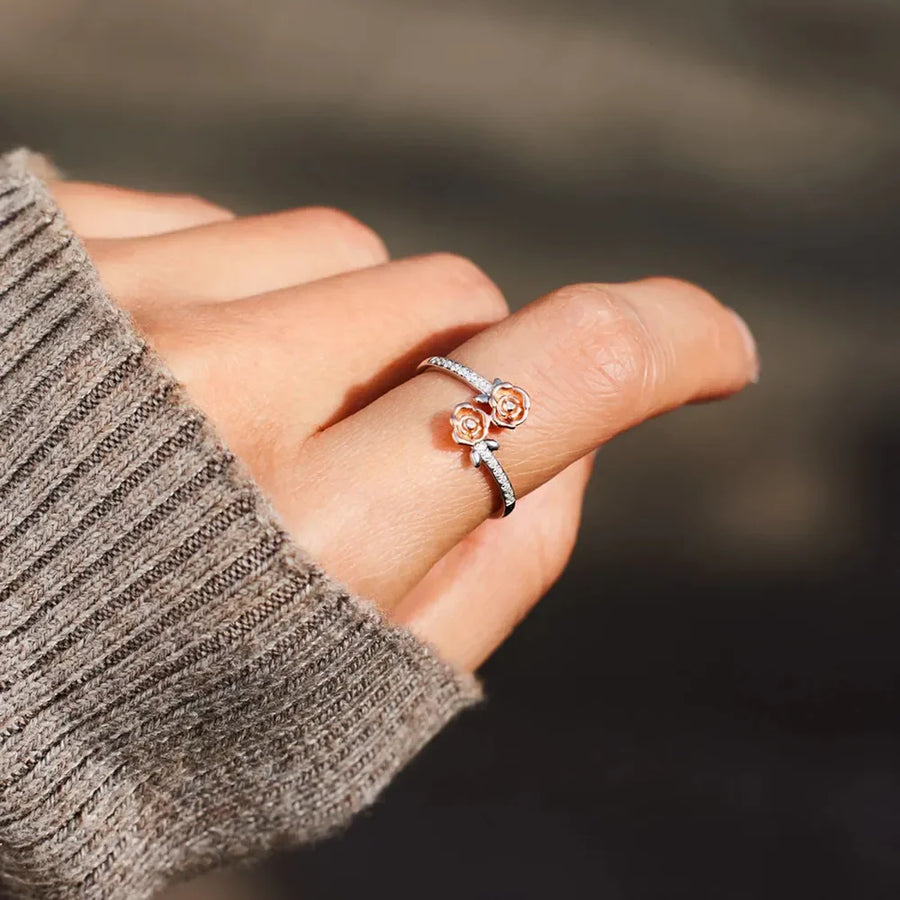 Silver bypass ring with two rosebud details and pavé accents.