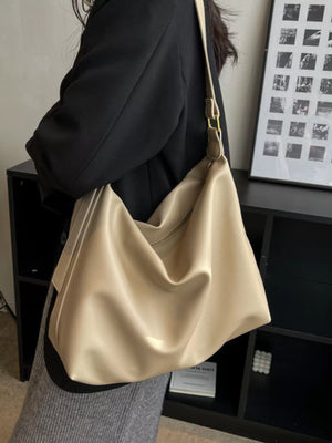 Khaki sculptural PU leather shoulder bag with adjustable strap and gold hardware.