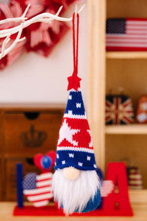Patriotic knit gnome ornament with red, white, and blue star pattern hat and white beard.