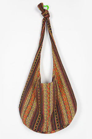 Tribal weave shoulder bag with multicolor geometric pattern and tasseled strap detail.