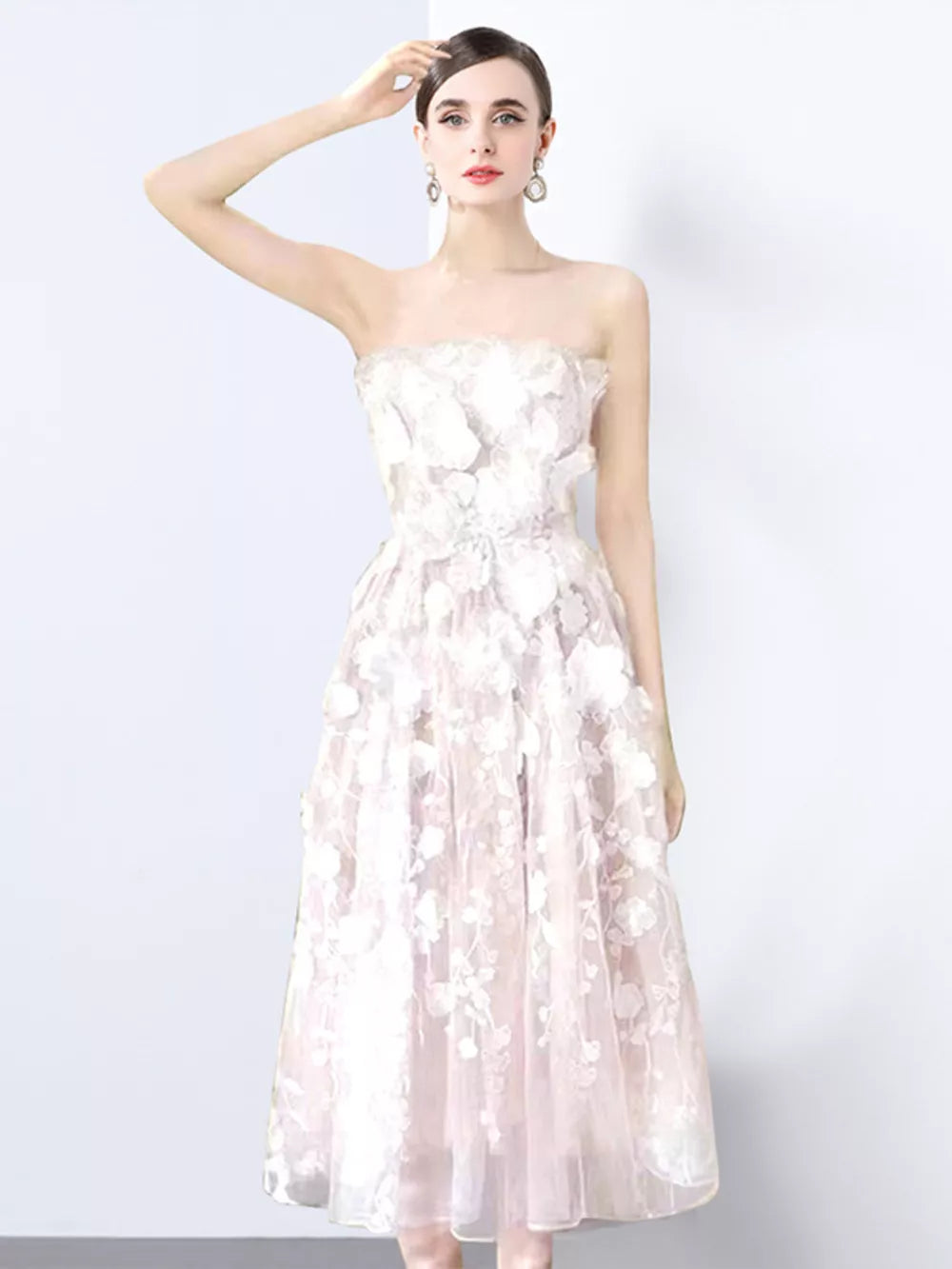 White strapless midi dress with 3D floral applique and sheer overlay.