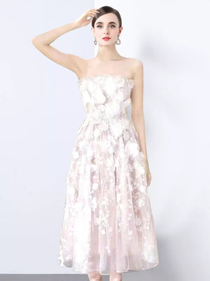 White strapless midi dress with 3D floral applique and sheer overlay.