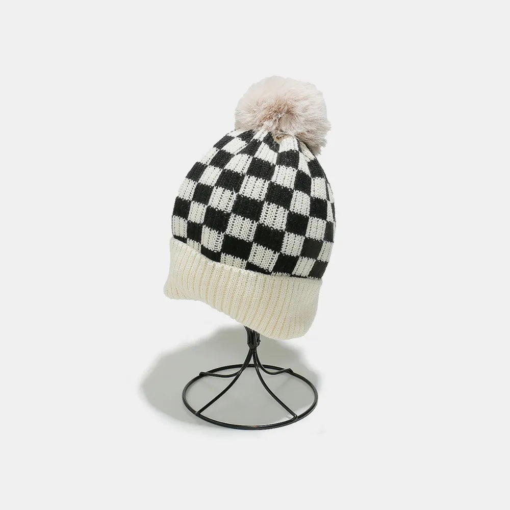 Checkerboard knit beanie with faux fur pom and ivory cuff