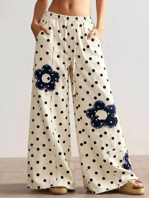 black wide-leg jeans featuring raw hem and polka-dot