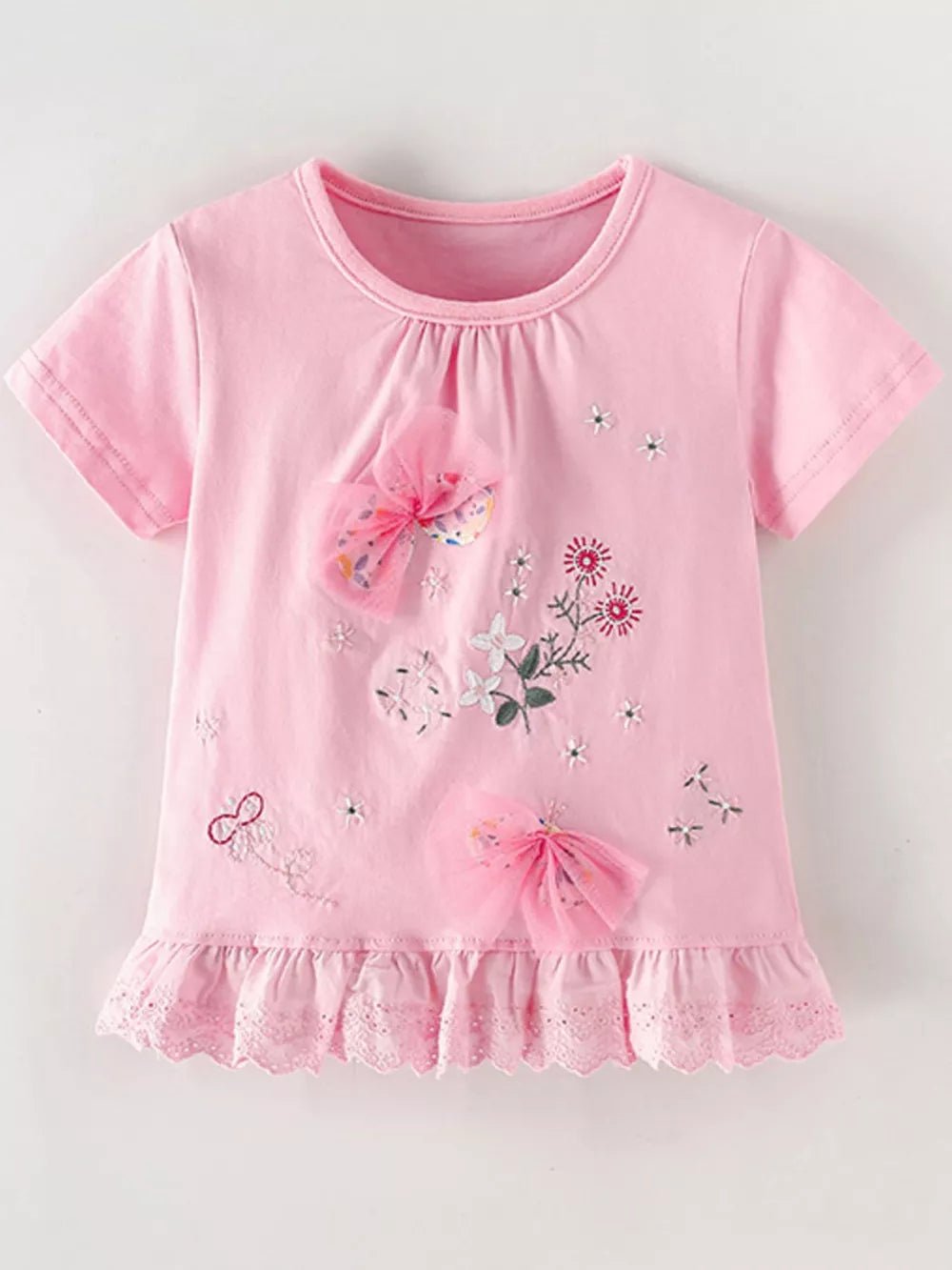 Pink cotton t-shirt with floral embroidery and tulle bows, ruffled lace hem.
