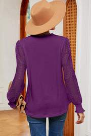 Violet knit top with lace long sleeves and ruffled cuffs.