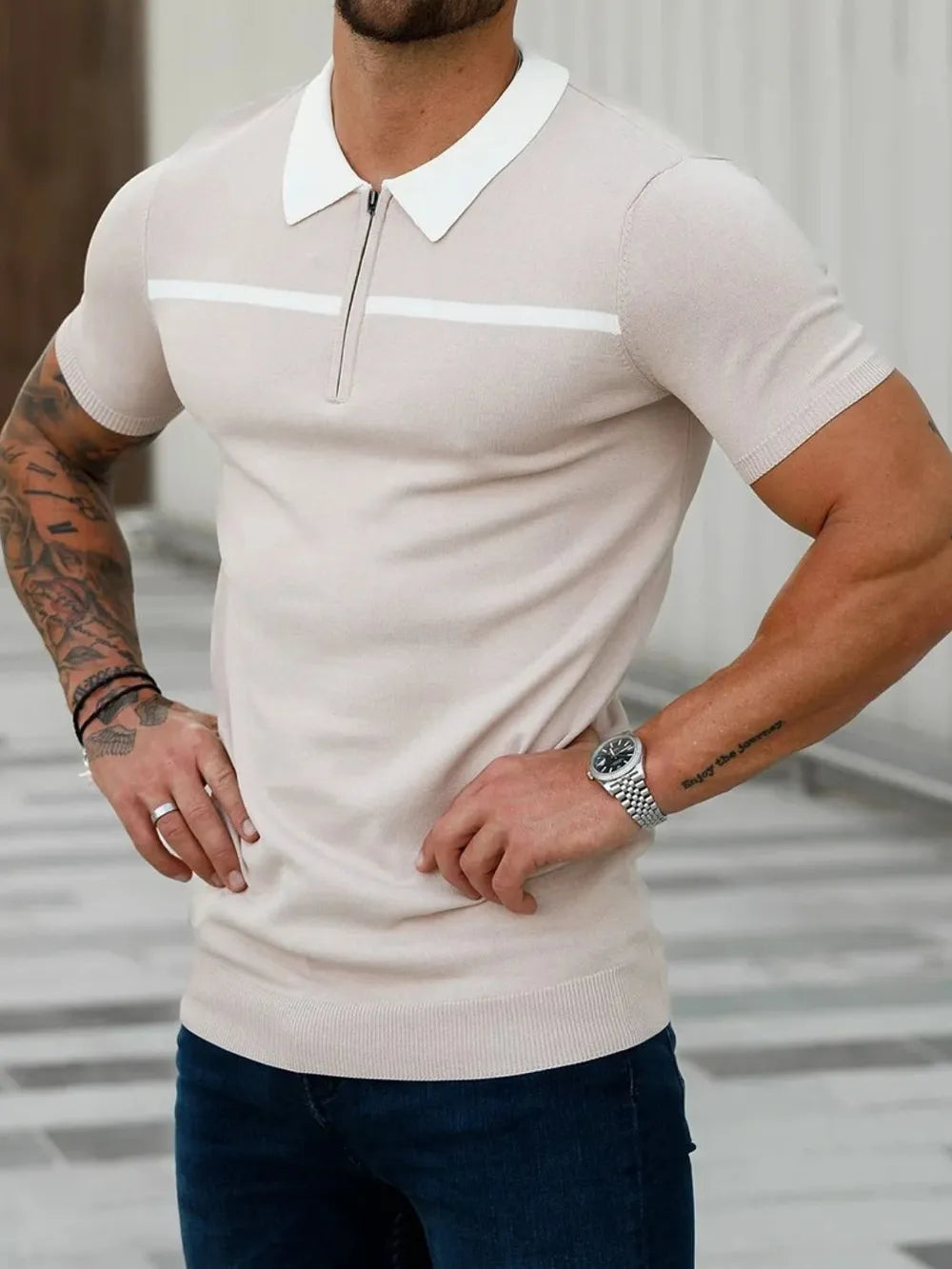Men's beige knit zip-neck polo shirt with contrast white trim and collar.