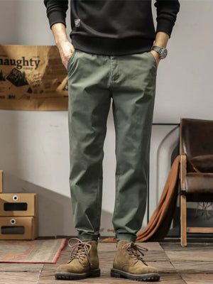 Men's plus size slim fit ankle pants in military green with a tapered leg and cuffed hem.