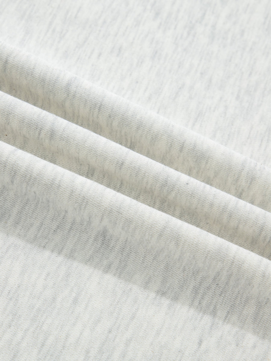 Light grey marled cotton casual top with button detail, showing fabric texture.