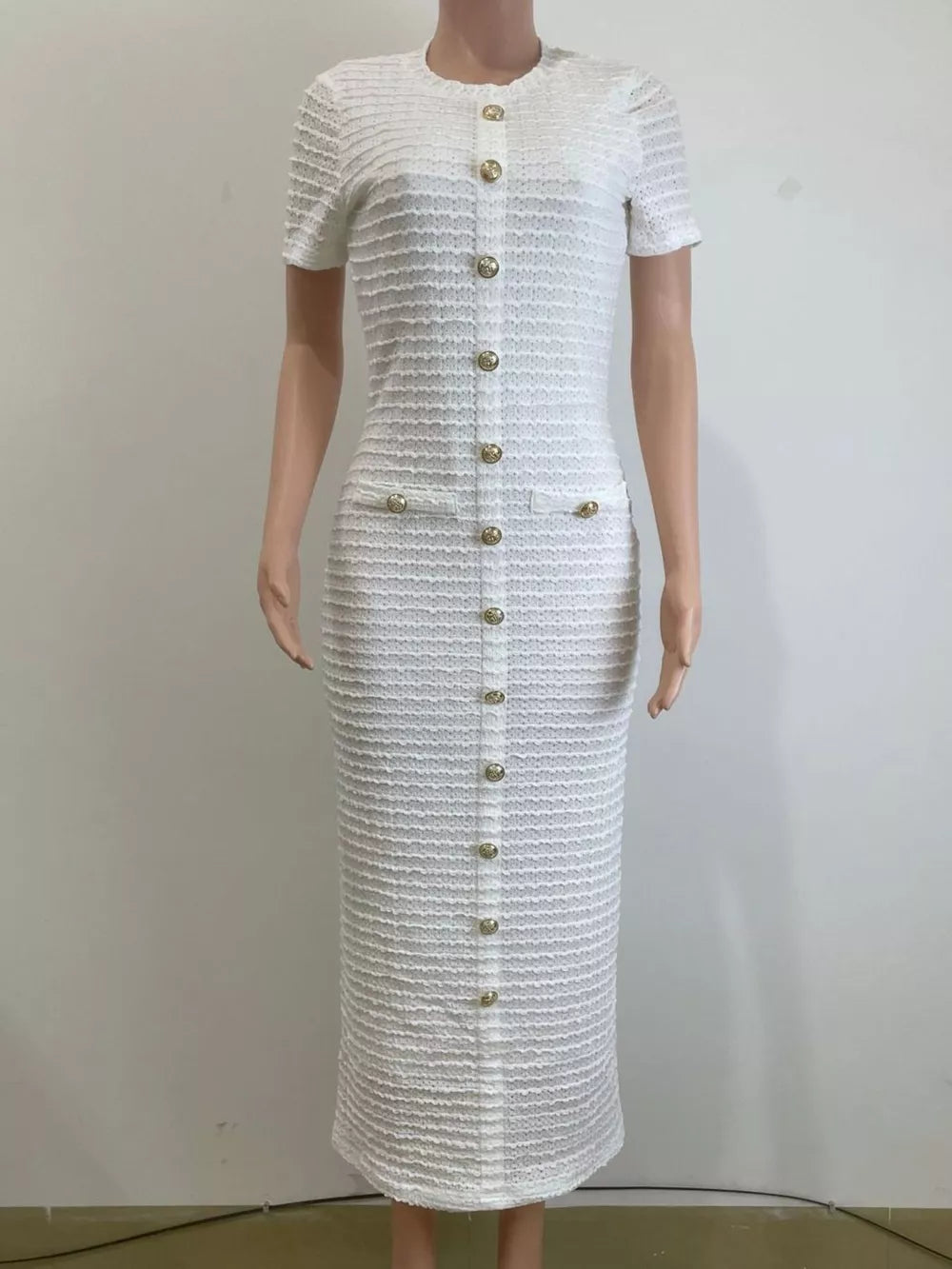 Textured ivory white midi dress with short sleeves, gold buttons, and two chest pockets.