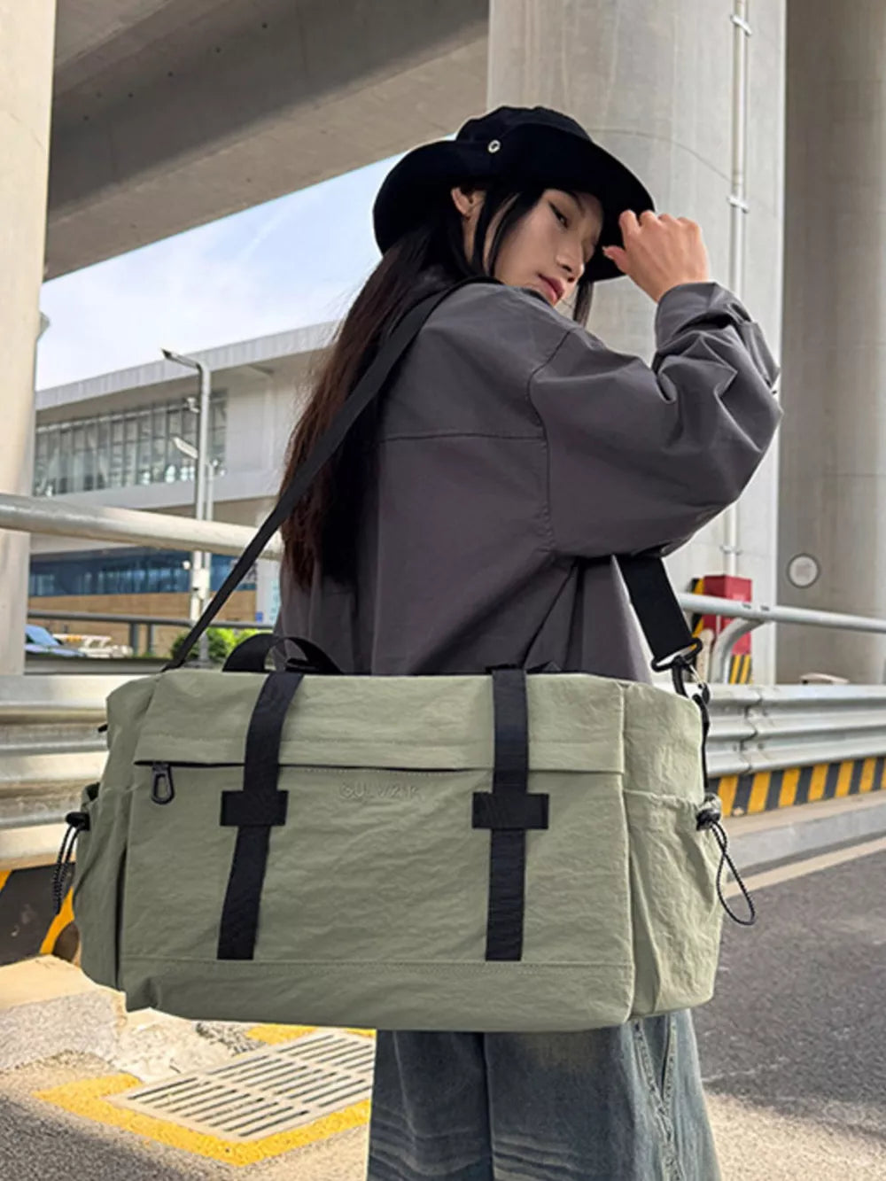 Spacious olive green duffel bag with adjustable strap and black accents.