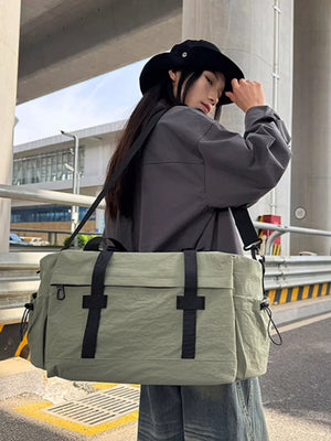 Spacious olive green duffel bag with adjustable strap and black accents.