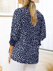Navy blue animal print blouse with smocked half sleeves and a round neckline.