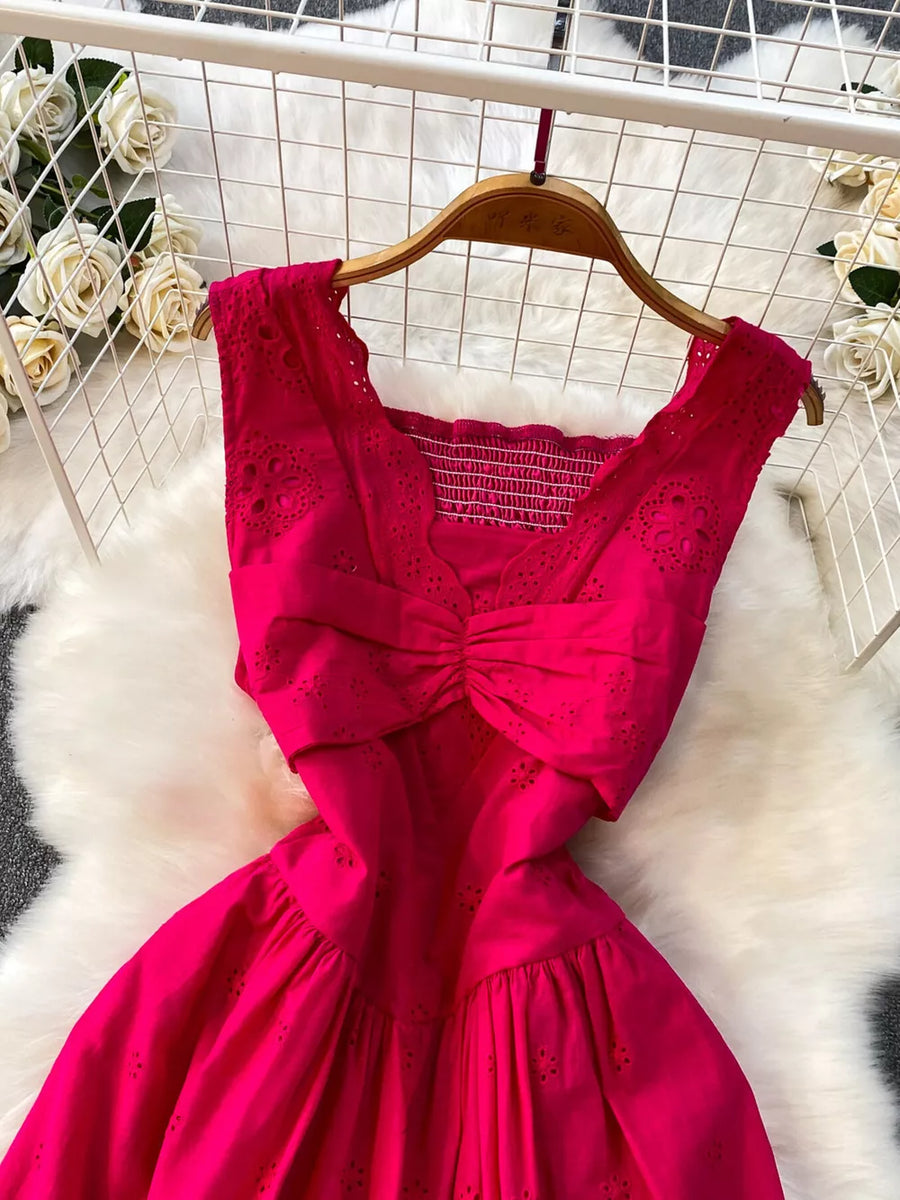 Charming eyelet maxi dress in hot pink with cutout detail and smocked bodice.