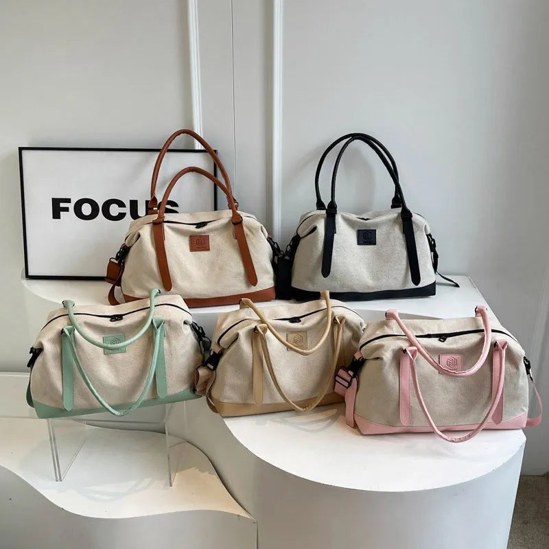 Canvas weekend holdall duffel bags in blush pink, khaki, gum leaf, black, and brown with leather accents.
