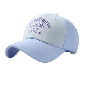 Two-tone baseball cap in sky blue and light blue with purple embroidery.