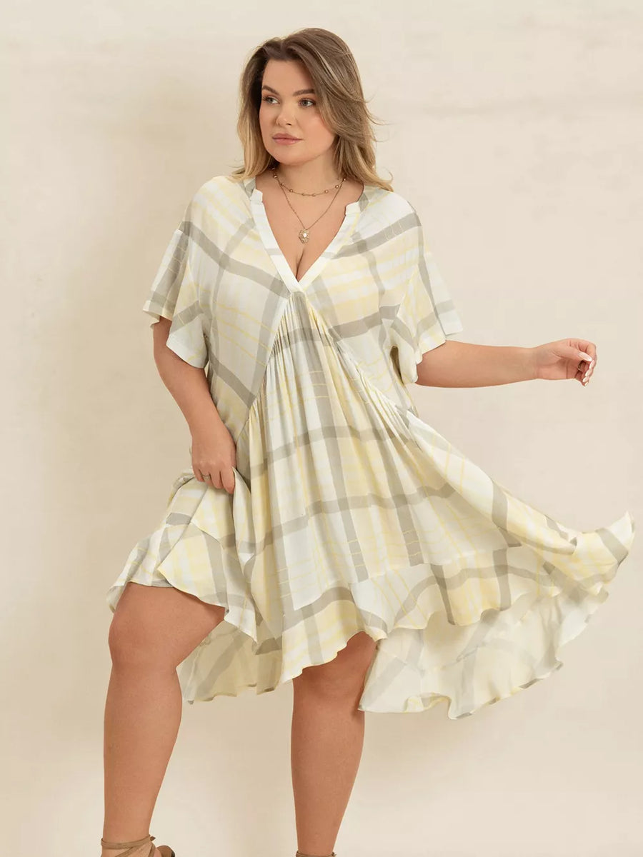 Plus size beige plaid flutter sleeve dress with V-neck and asymmetrical hem.