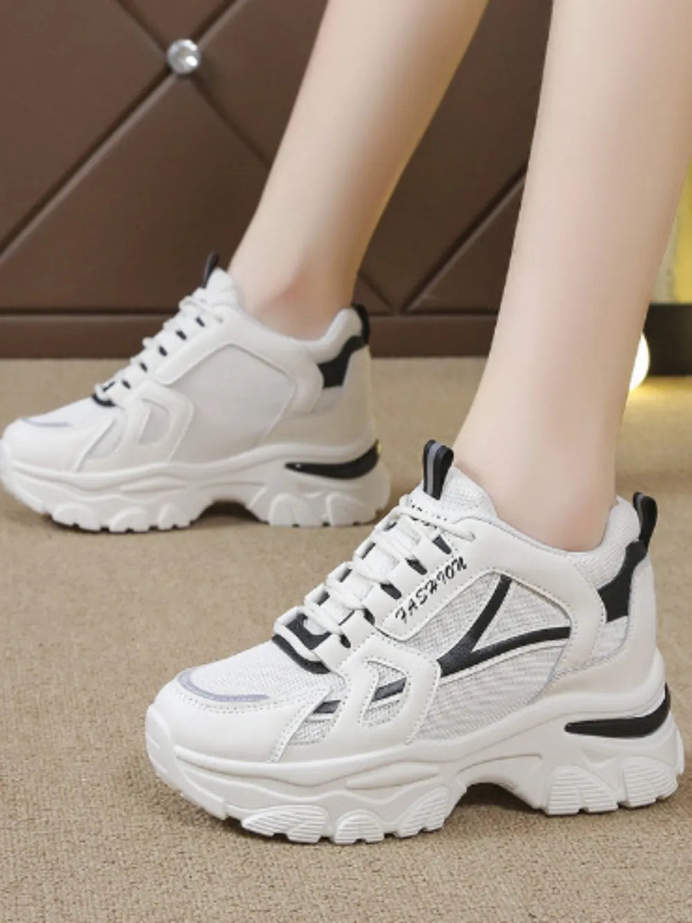 White chunky sneakers with textured mesh and leather details.