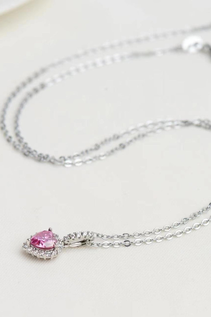 Pink heart halo pendant necklace in 925 sterling silver with clear accent stones.