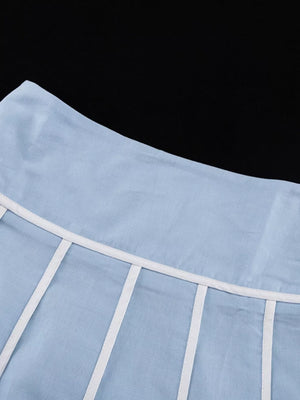 Light blue linen skirt with white piping detail at the waist