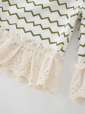 White cotton tee with green zigzag print and beige eyelet lace ruffle trim.