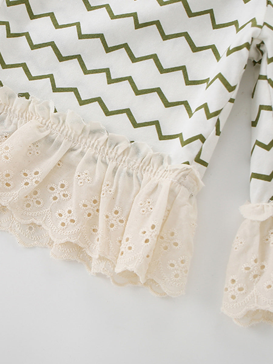 White cotton tee with green zigzag print and beige eyelet lace ruffle trim.