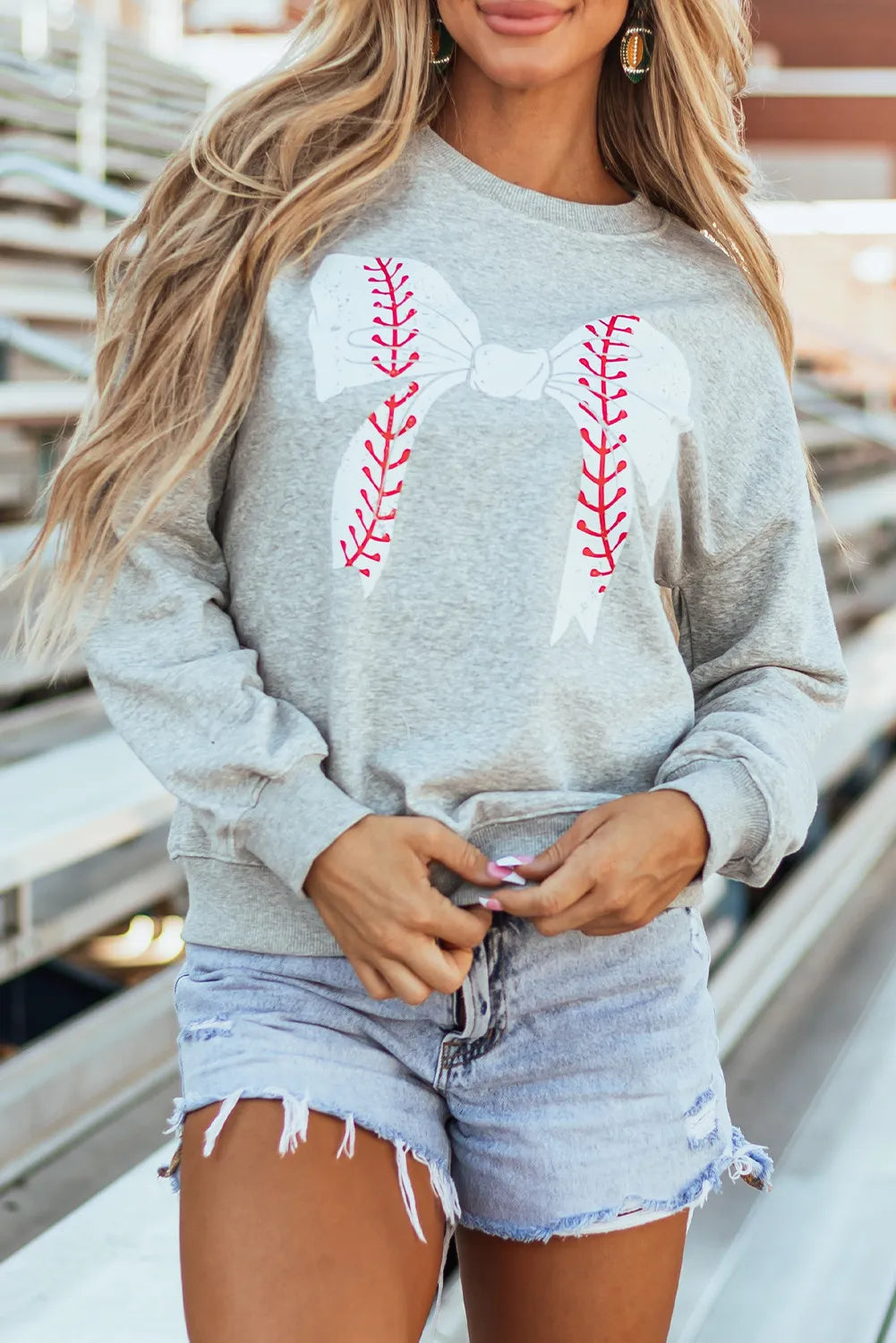 Gray sweatshirt with a white baseball stitch bow graphic.