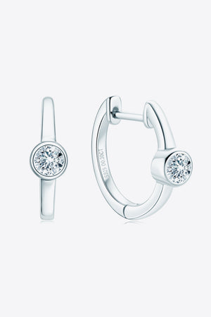 Silver bezel-set sparkle huggie hoop earrings with a single clear stone.