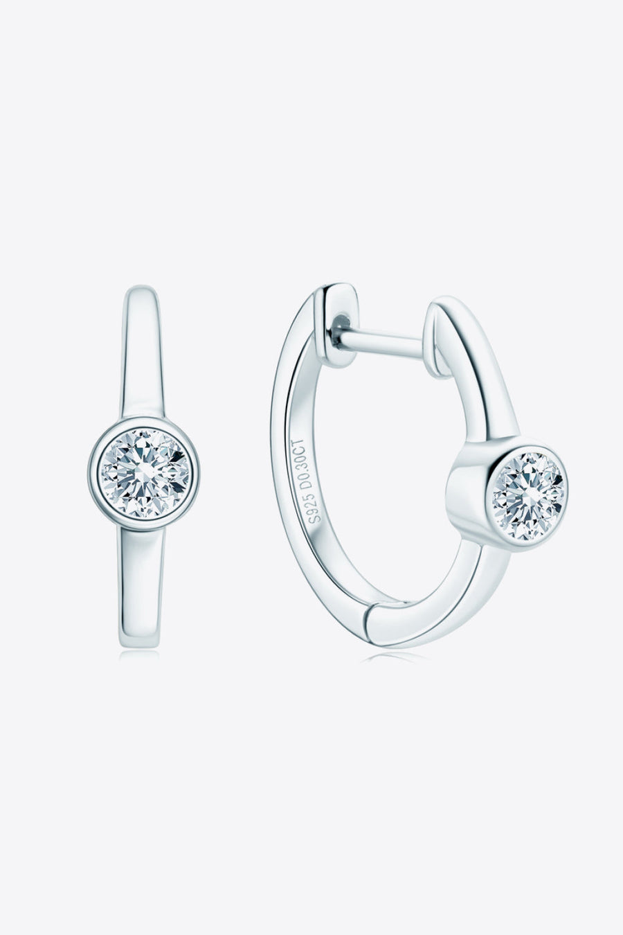 Silver bezel-set sparkle huggie hoop earrings with a single clear stone.