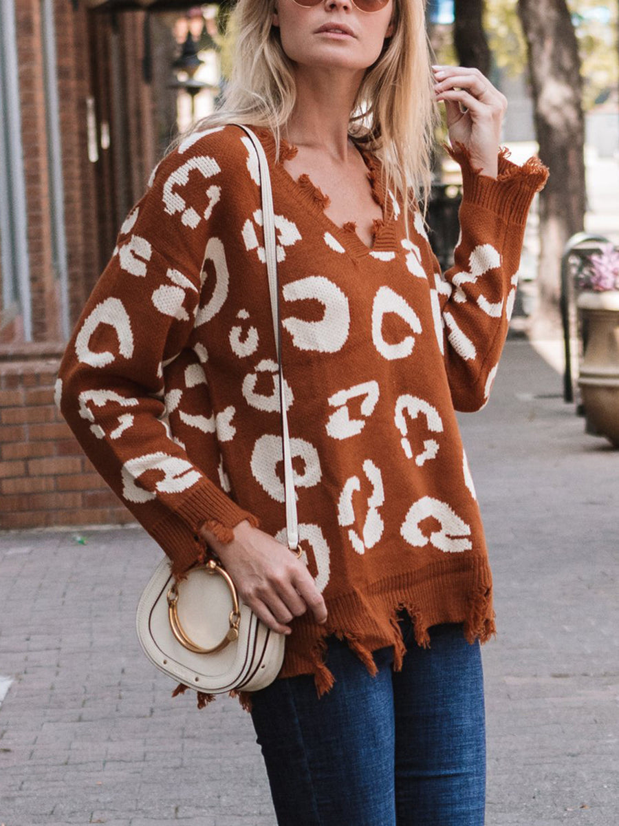 Brown leopard print knit sweater with distressed raw edges and V-neck.